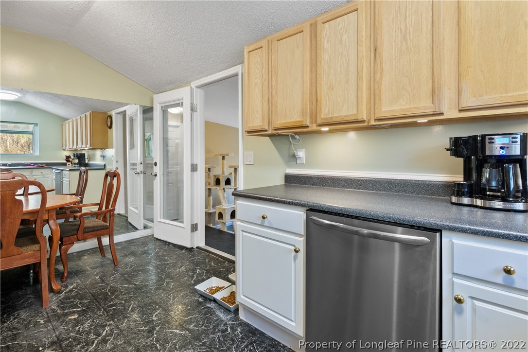 628 Tc Jones Road Raeford, NC 28376 - Photo 19 of 46 a kitchen with stainless steel appliances granite countertop a refrigerator sink and cabinets