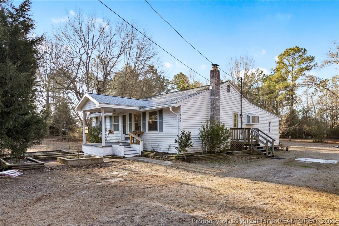 628 Tc Jones Road Raeford, NC 28376 - Photo 2 of 46 a front view of house with yard outdoor seating and barbeque oven
