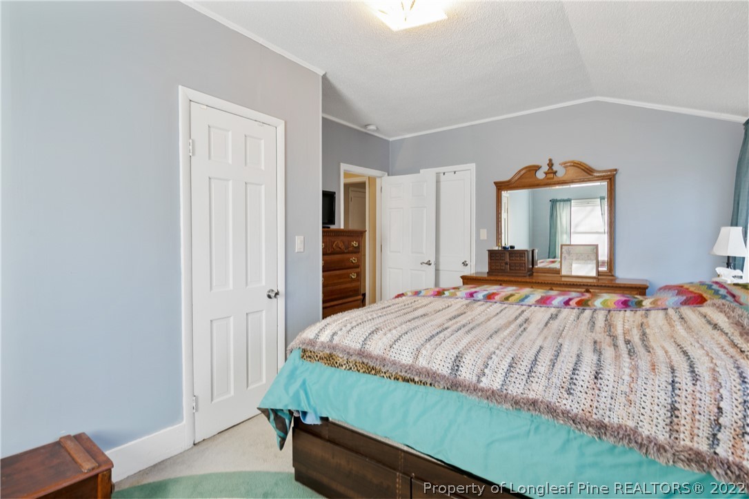 628 Tc Jones Road Raeford, NC 28376 - Photo 27 of 46 a bedroom with a bed and a dresser