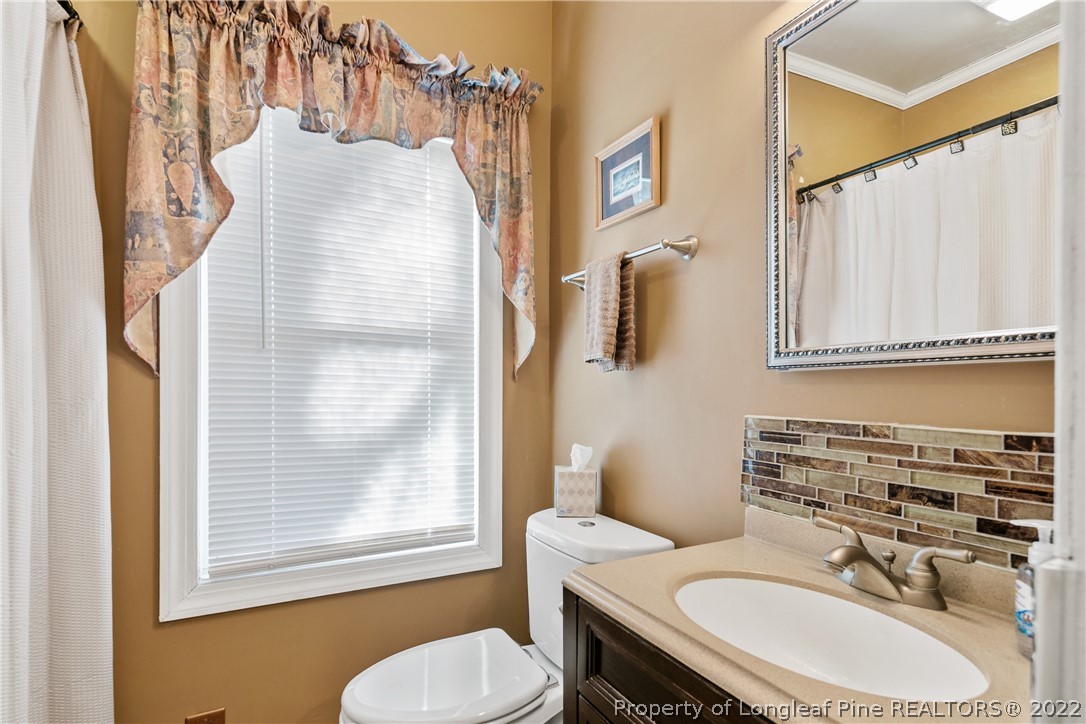 628 Tc Jones Road Raeford, NC 28376 - Photo 37 of 46 a bathroom with a sink toilet and mirror