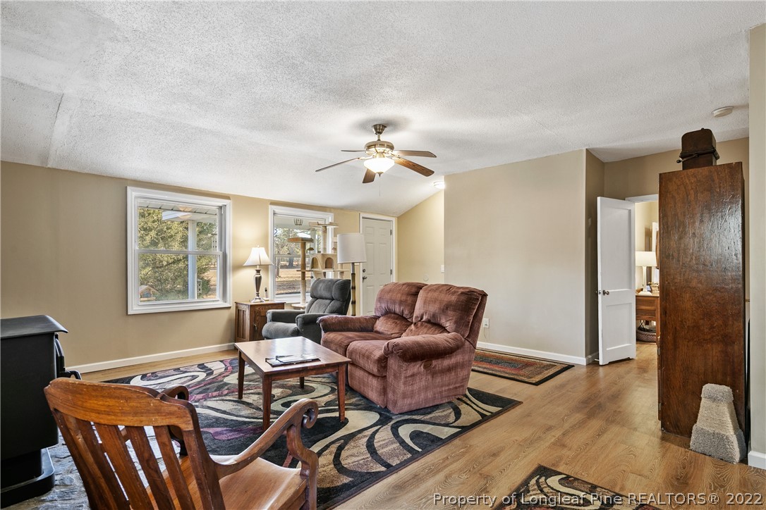 628 Tc Jones Road Raeford, NC 28376 - Photo 10 of 46 a living room with furniture a chandelier and a window