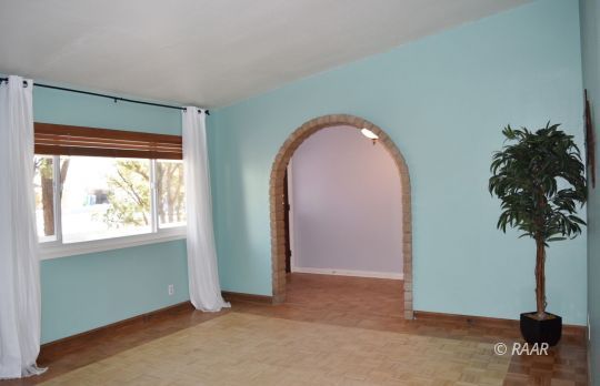 313 South Lilac Street Ridgecrest, CA 93555 - Photo 5 of 26 a view of a room that has a window and a potted plant