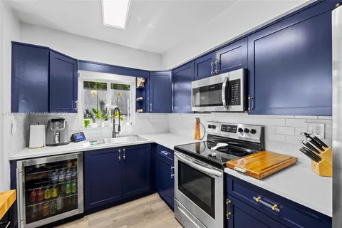 a kitchen with stainless steel appliances wooden cabinets a sink and a stove