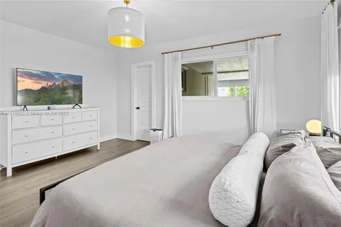 a living room with furniture and mirror