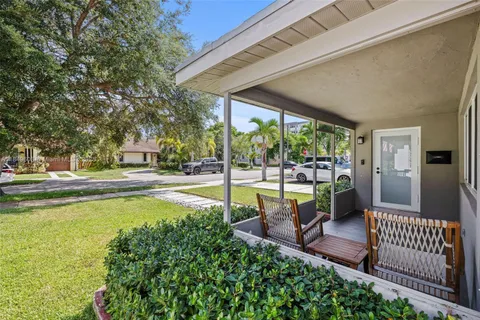 a view of swimming pool with lawn chairs and patio