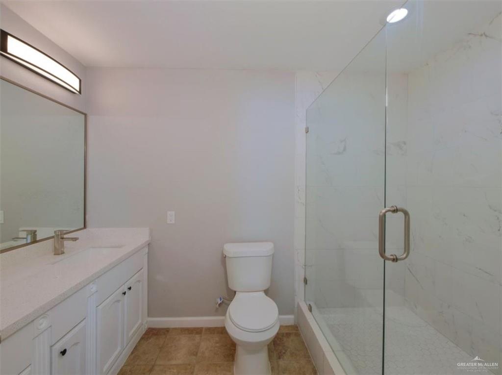 4507 West Rogers Road Edinburg, TX 78541 - Photo 13 of 21 a spacious bathroom with a toilet sink and a mirror