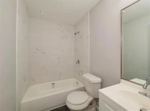 a bathroom with a toilet a sink and bathtub