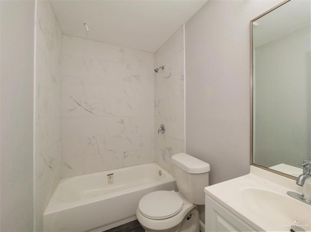 4507 West Rogers Road Edinburg, TX 78541 - Photo 15 of 21 a bathroom with a toilet a sink and bathtub