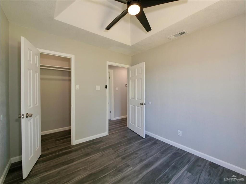 4507 West Rogers Road Edinburg, TX 78541 - Photo 16 of 21 an empty room with wooden floor and windows