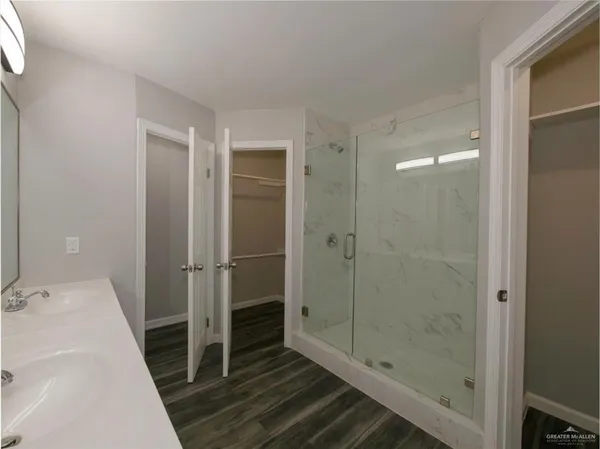 a bathroom with a shower and a sink
