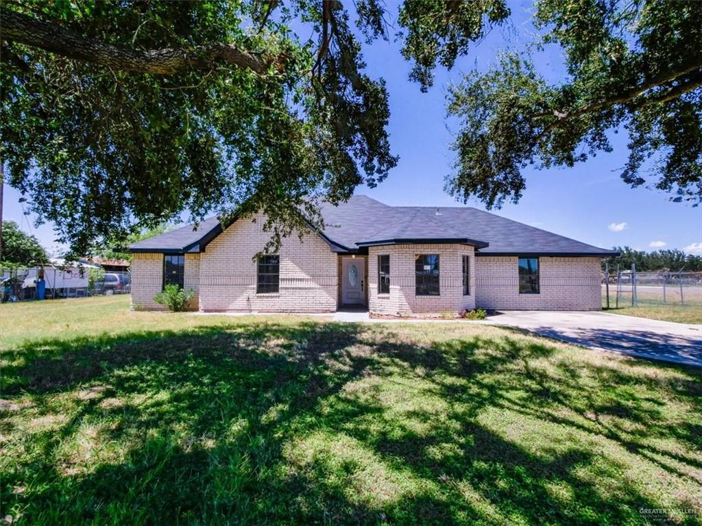 4507 West Rogers Road Edinburg, TX 78541 - Photo 4 of 21 a front view of a house with a yard and garage