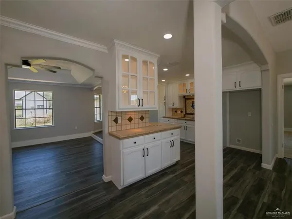 a kitchen with granite countertop a sink and cabinets