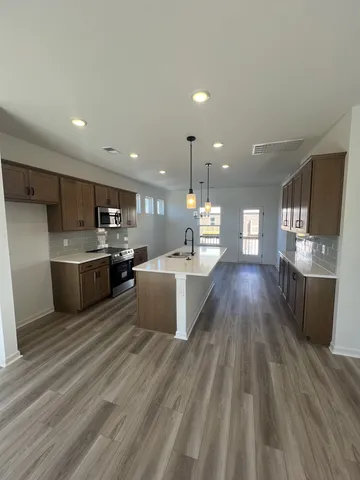 a kitchen with a sink window and cabinets
