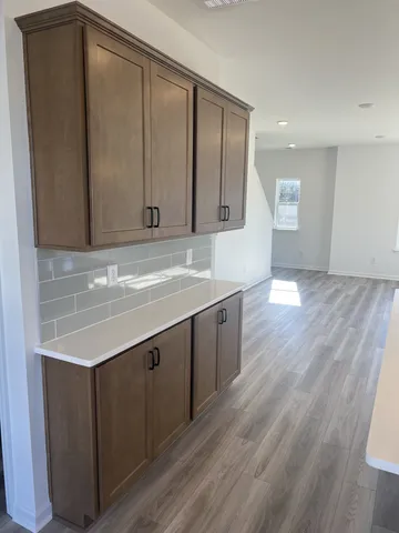 a view of empty room with window and wooden floor