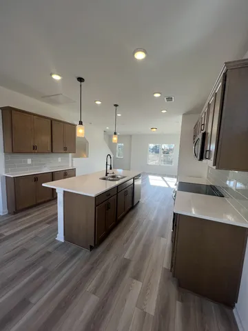 a kitchen with a sink stainless steel appliances and cabinets