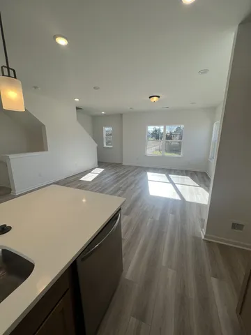 a view of a dining room with furniture a chandelier and wooden floor
