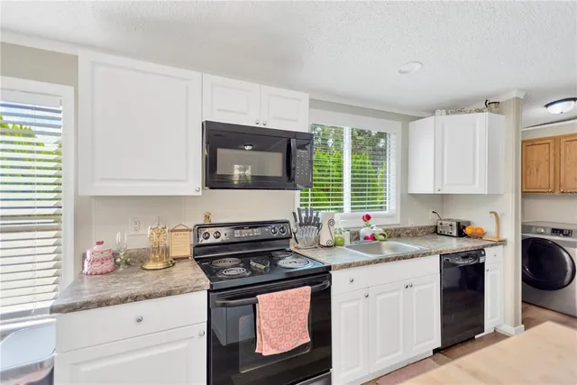 a kitchen with stainless steel appliances a sink stove and cabinets