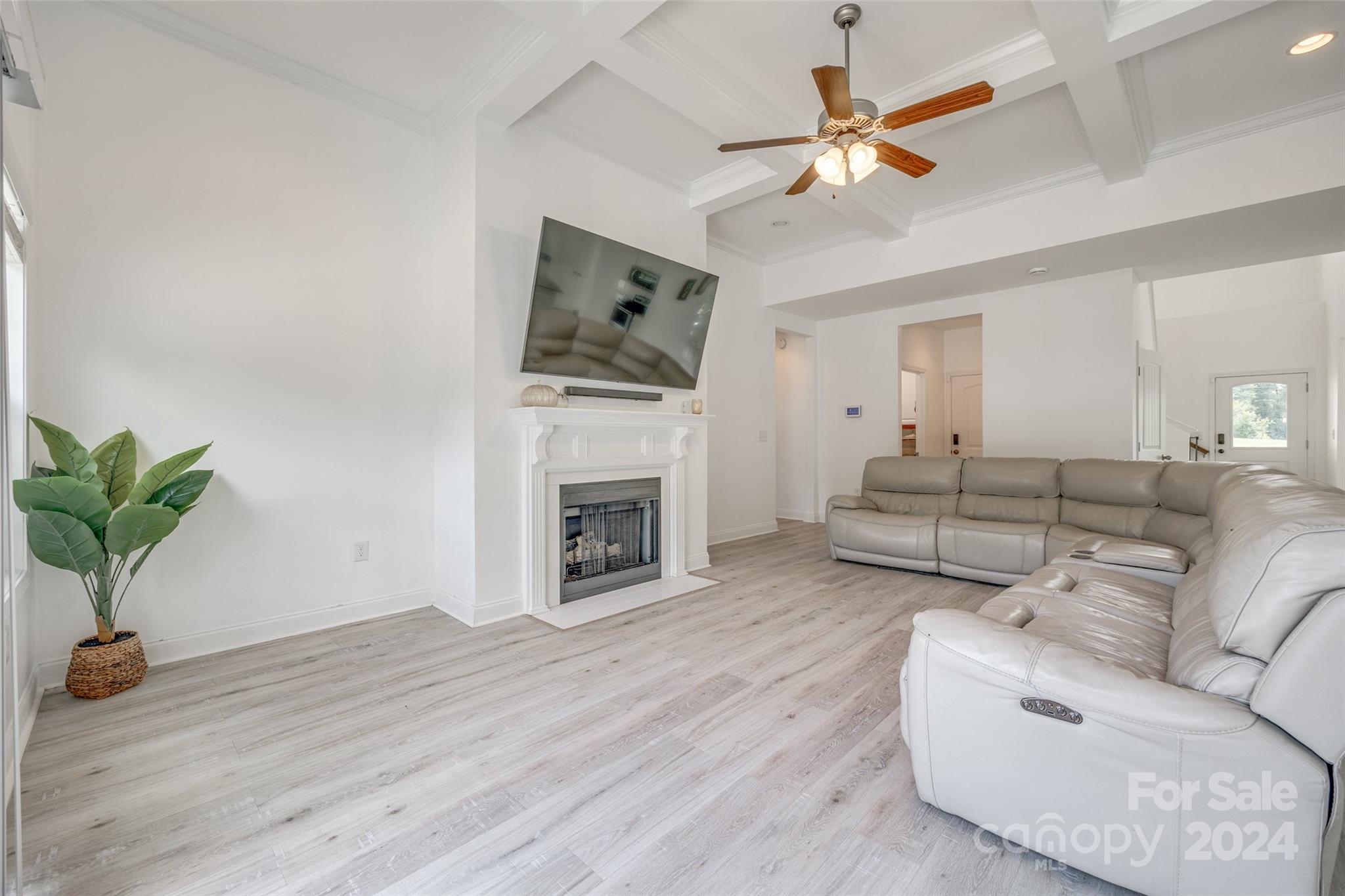 4725 Olive Branch Road Wingate, NC 28174 - Photo 15 of 39 a living room with furniture a fireplace and a flat screen tv