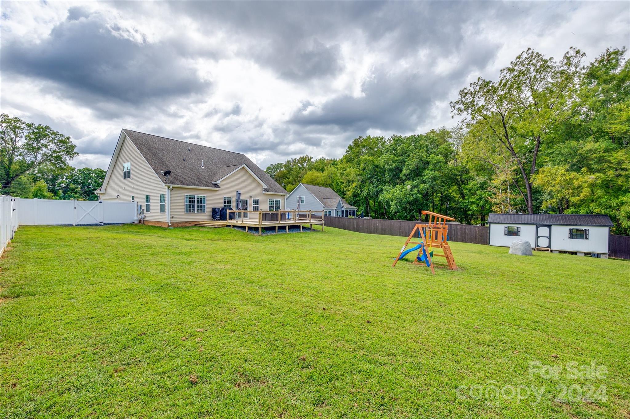 4725 Olive Branch Road Wingate, NC 28174 - Photo 36 of 39 a house view with swimming pool and trees in the background