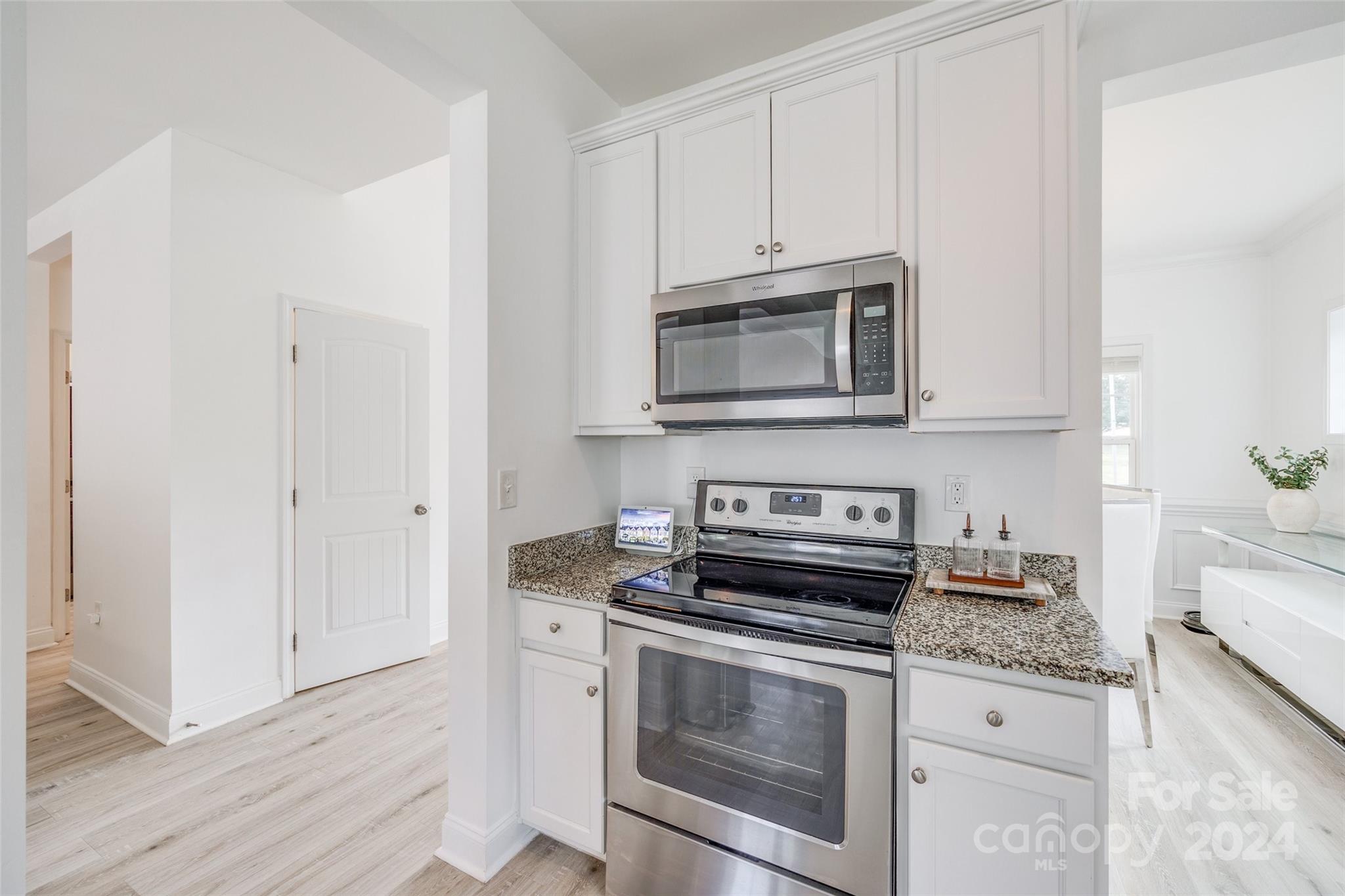 4725 Olive Branch Road Wingate, NC 28174 - Photo 8 of 39 a kitchen with granite countertop cabinets stainless steel appliances and wooden floor