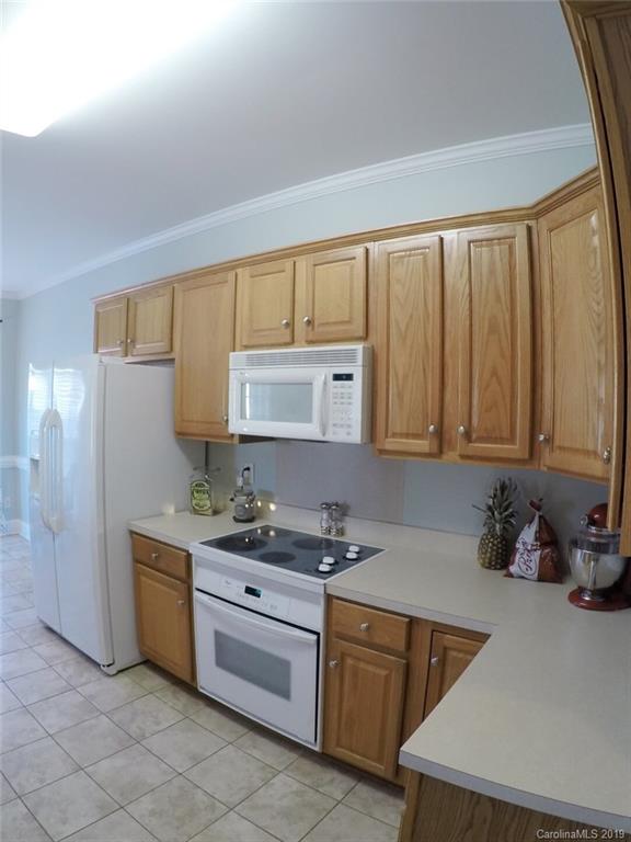 1407 Henry Smith Road Monroe, NC 28110 - Photo 8 of 23 a kitchen with stainless steel appliances granite countertop a sink stove and refrigerator
