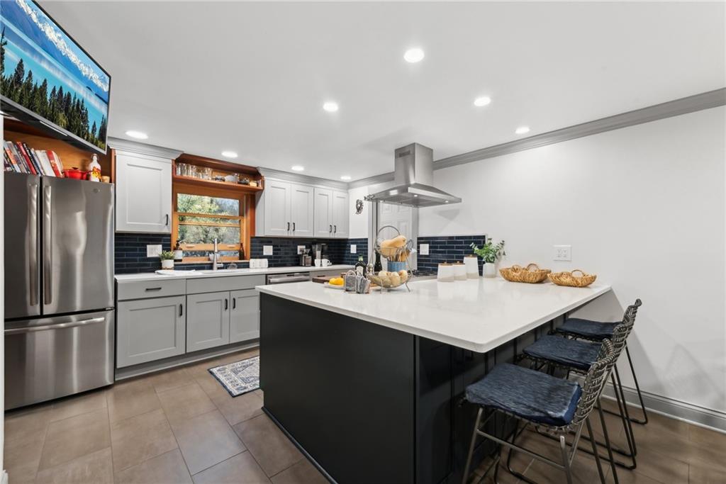 490 Haverhill Road Pittsburgh, PA 15228 - Photo 10 of 46 a kitchen with stainless steel appliances a sink a counter top space cabinets and wooden floor