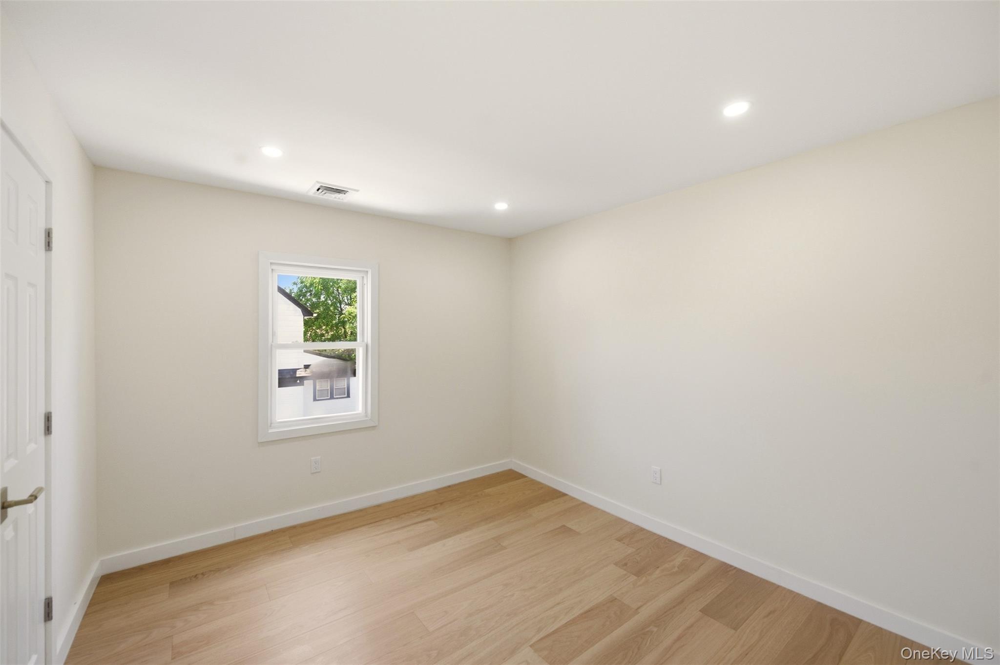 135 Whaley Street Freeport, NY 11520 - Photo 29 of 38 an empty room with a window