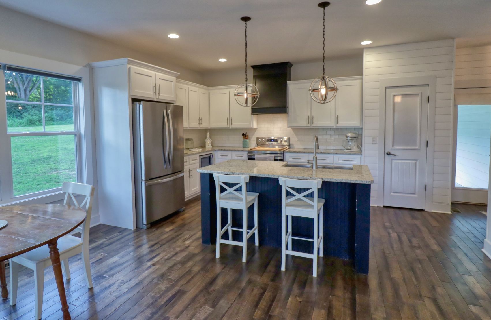 1658 Center Star Road Columbia, TN 38401 - Photo 9 of 36 a kitchen with stainless steel appliances granite countertop a table chairs refrigerator and microwave
