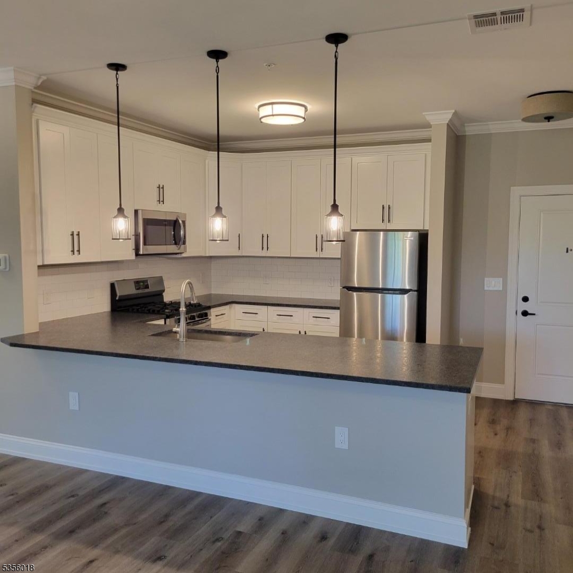 2435 Lamington Road, Unit 33 Bedminster, NJ 07921 - Photo 3 of 9 a kitchen with stainless steel appliances granite countertop a sink a refrigerator a stove and a granite counter tops