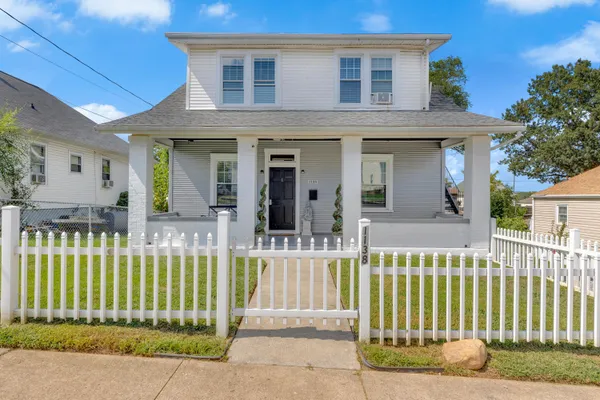 a front view of a house with a small garden
