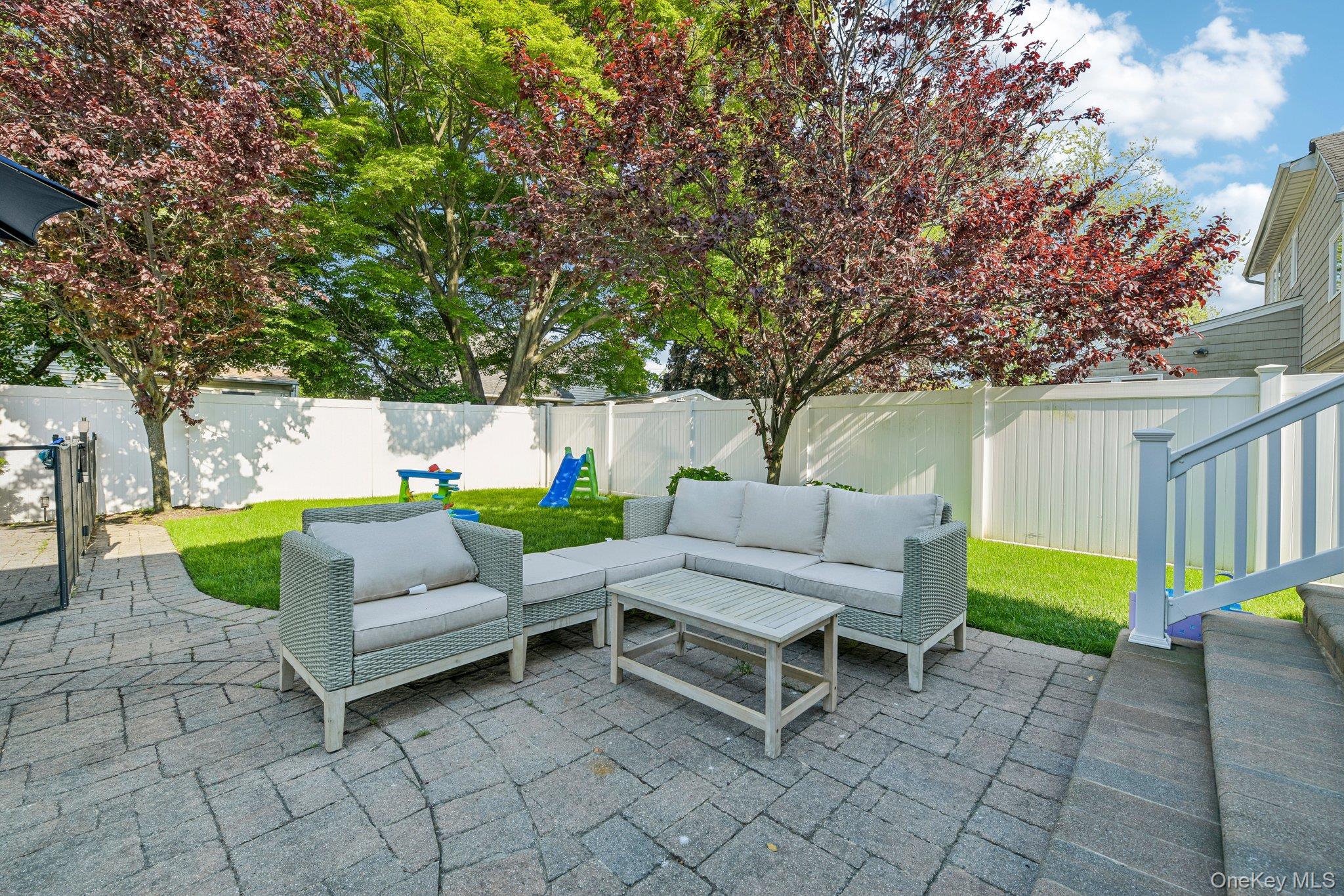 2821 Colonial Avenue Merrick, NY 11566 - Photo 28 of 29 a backyard of a house with table and chairs