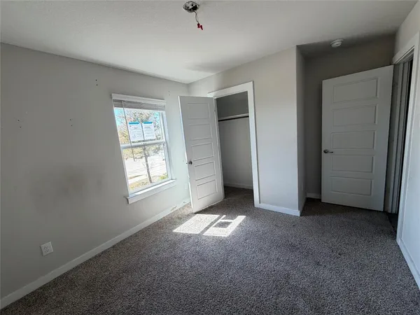 a room with a door and wooden floor