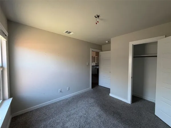 an empty room with closet area