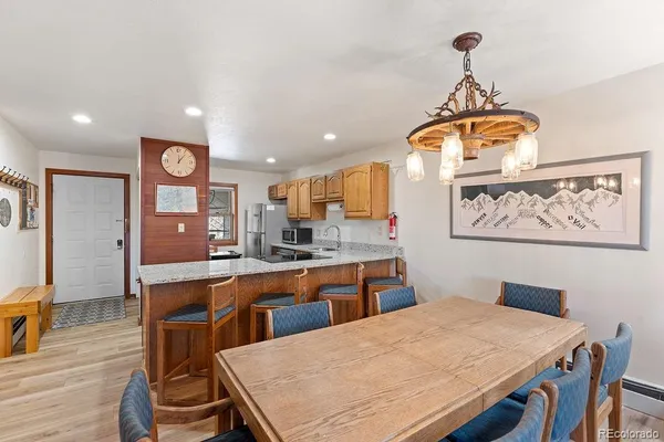 a large kitchen with a table and chairs