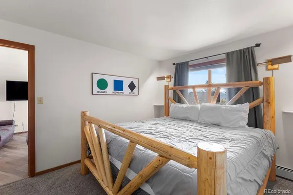 a bed sitting in a bedroom next to a window