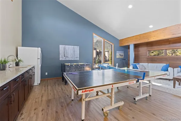 a living room with chairs and wooden floor