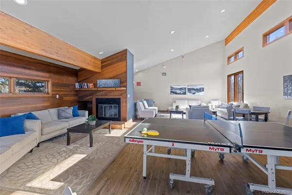 a living room with furniture a fireplace and a large window