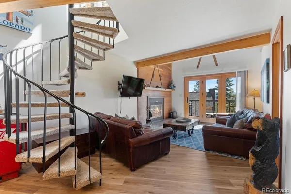 a living room with furniture and a floor to ceiling window