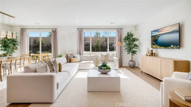 a bedroom with a bed and a potted plant next to a window