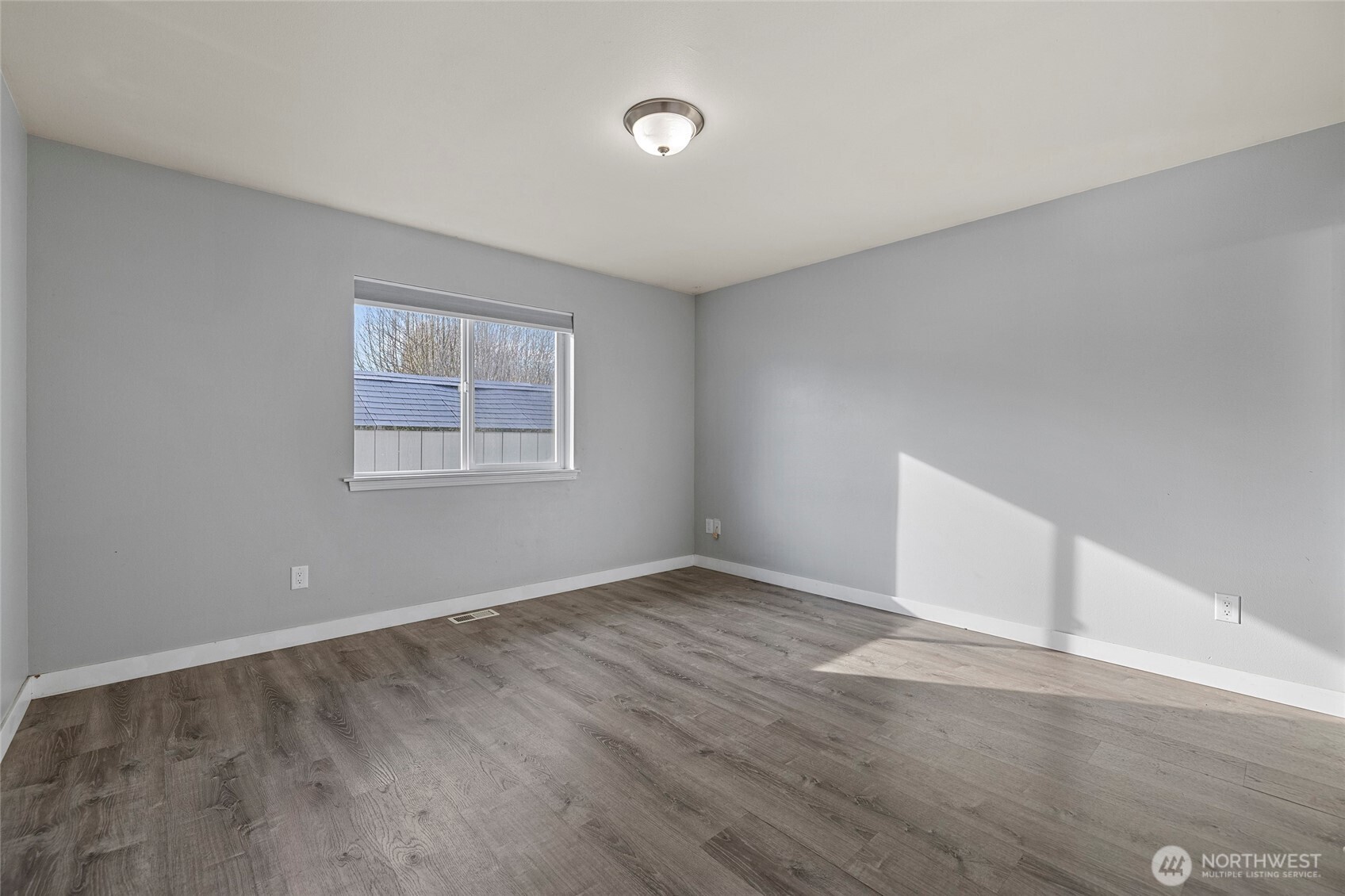 827 John Liner Road Sedro-Woolley, WA 98284 - Photo 15 of 36 an empty room with wooden floor and windows