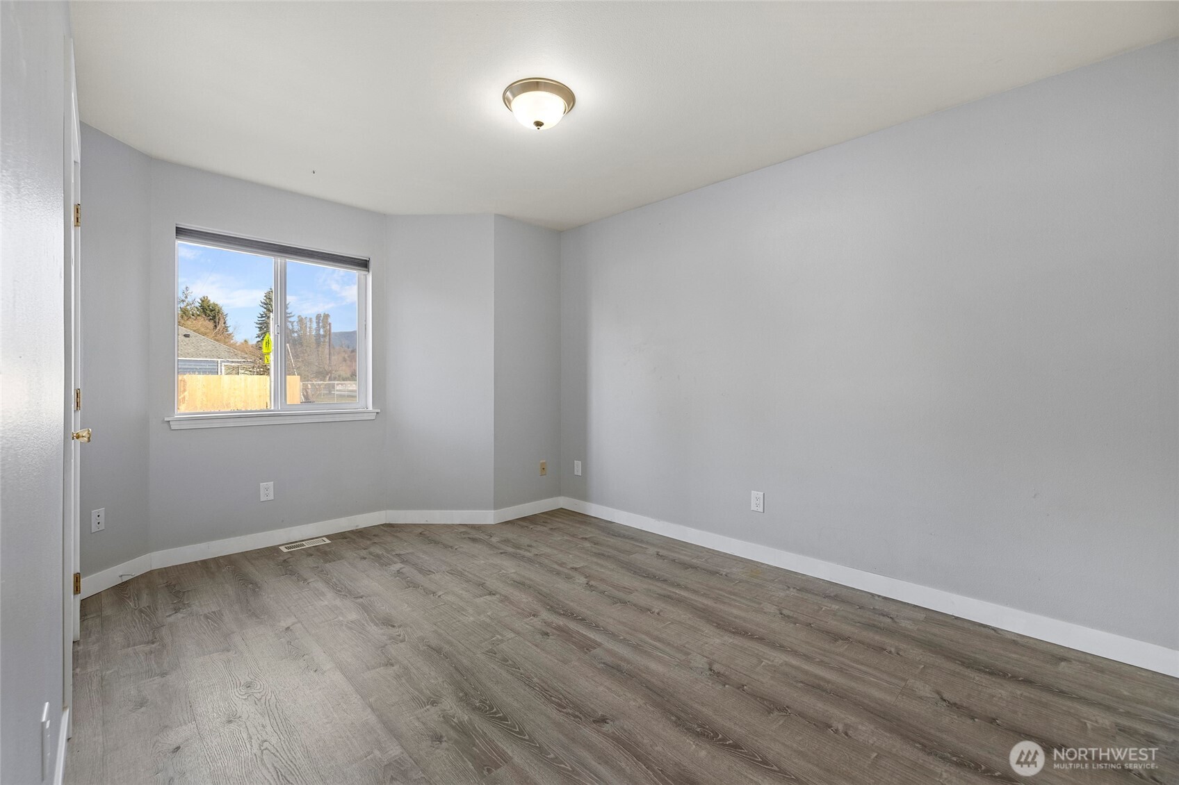 827 John Liner Road Sedro-Woolley, WA 98284 - Photo 18 of 36 a view of an empty room with wooden floor and a window