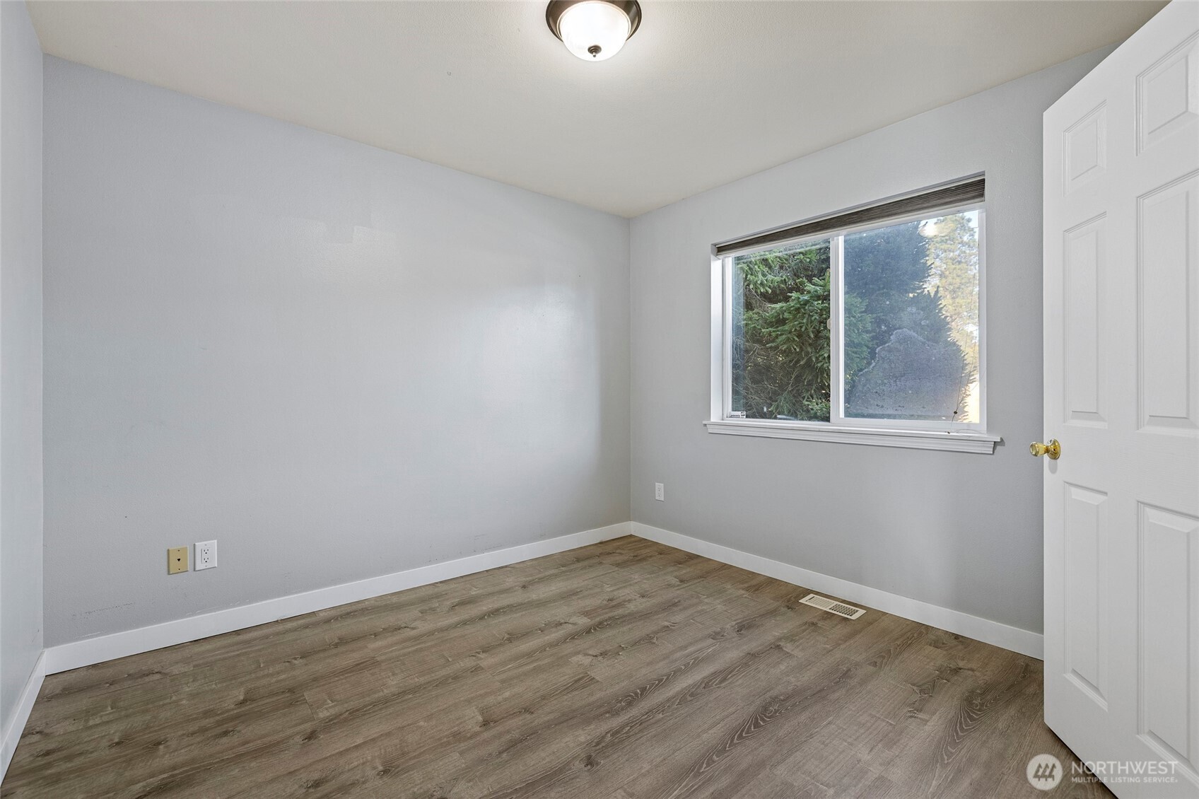 827 John Liner Road Sedro-Woolley, WA 98284 - Photo 19 of 36 a view of an empty room with wooden floor and a window