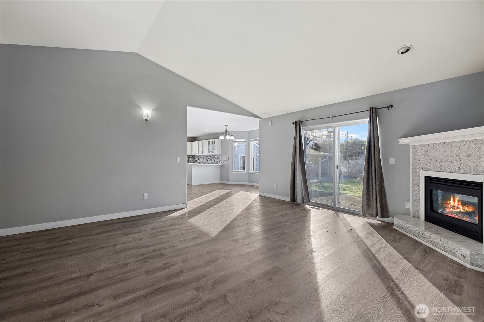 827 John Liner Road Sedro-Woolley, WA 98284 - Photo 5 of 36 a view of an empty room with wooden floor fireplace and a window