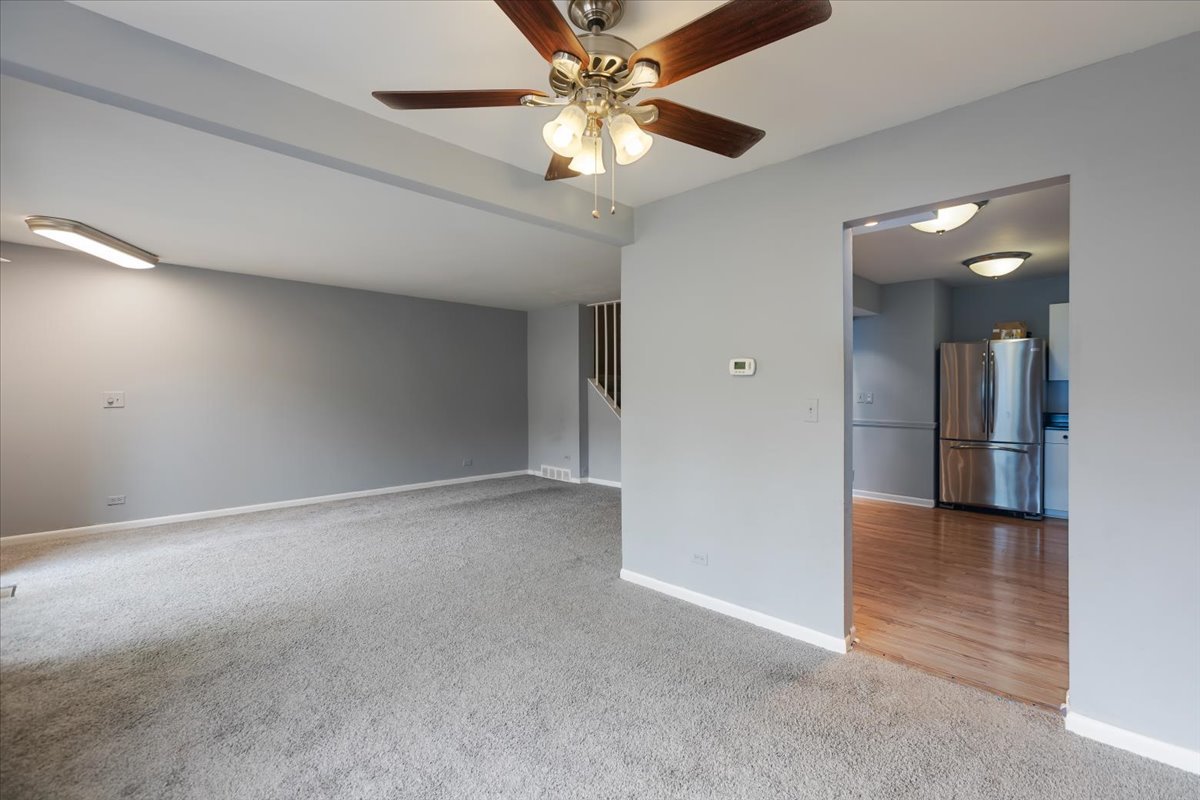 246 Monroe Road Bolingbrook, IL 60440 - Photo 11 of 32 a view of an empty room with a ceiling fan