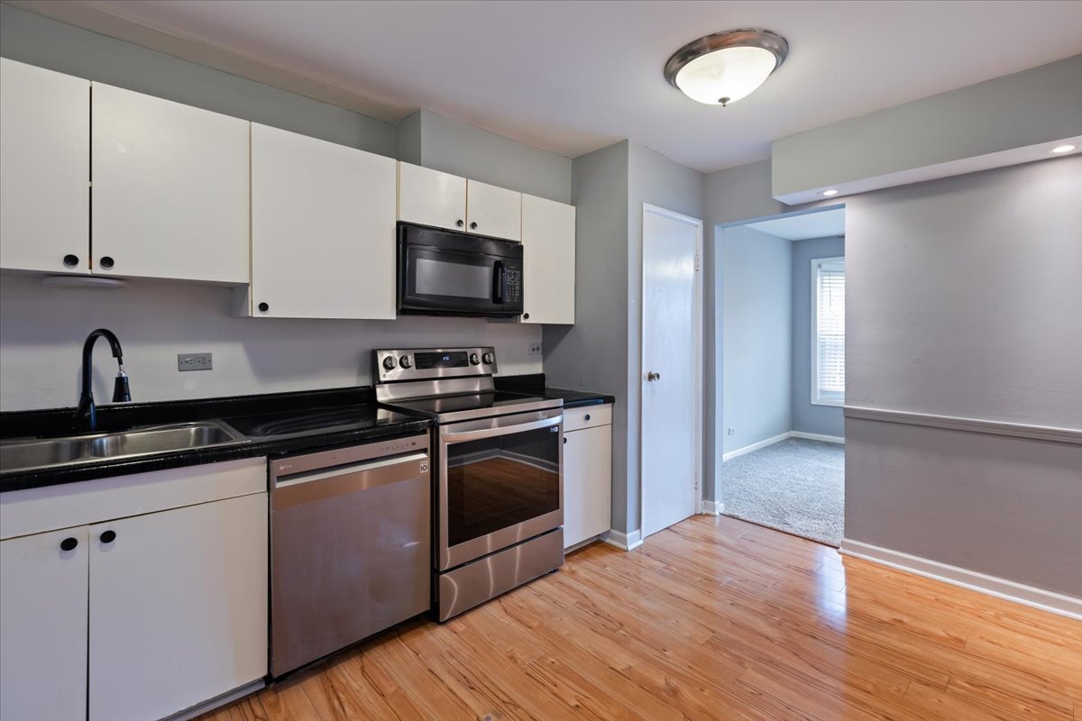 246 Monroe Road Bolingbrook, IL 60440 - Photo 12 of 32 a kitchen with granite countertop a sink and steel appliances
