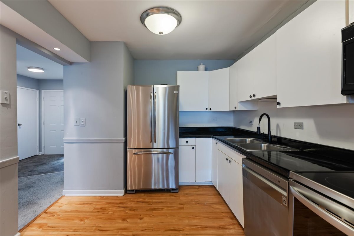 246 Monroe Road Bolingbrook, IL 60440 - Photo 13 of 32 a kitchen with a refrigerator sink and cabinets