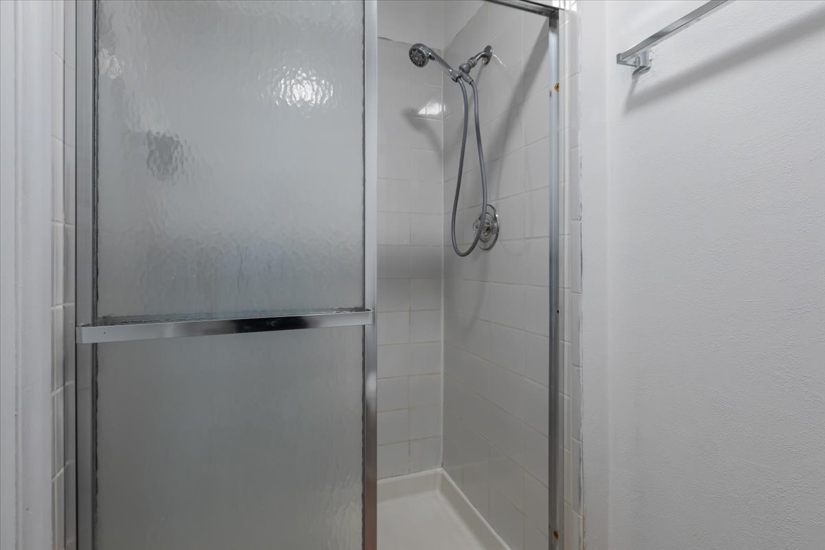 246 Monroe Road Bolingbrook, IL 60440 - Photo 18 of 32 a bathroom with a glass shower door
