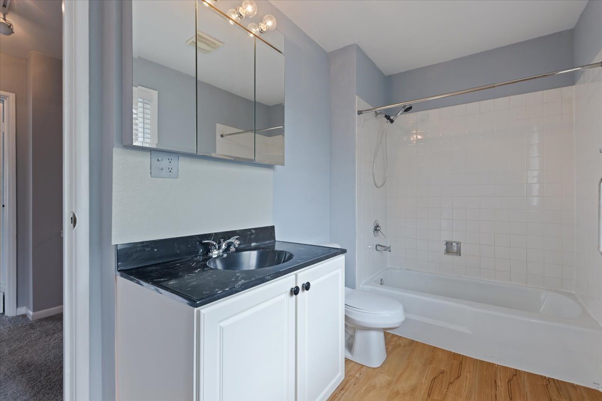 246 Monroe Road Bolingbrook, IL 60440 - Photo 23 of 32 a bathroom with a granite countertop sink a toilet and shower