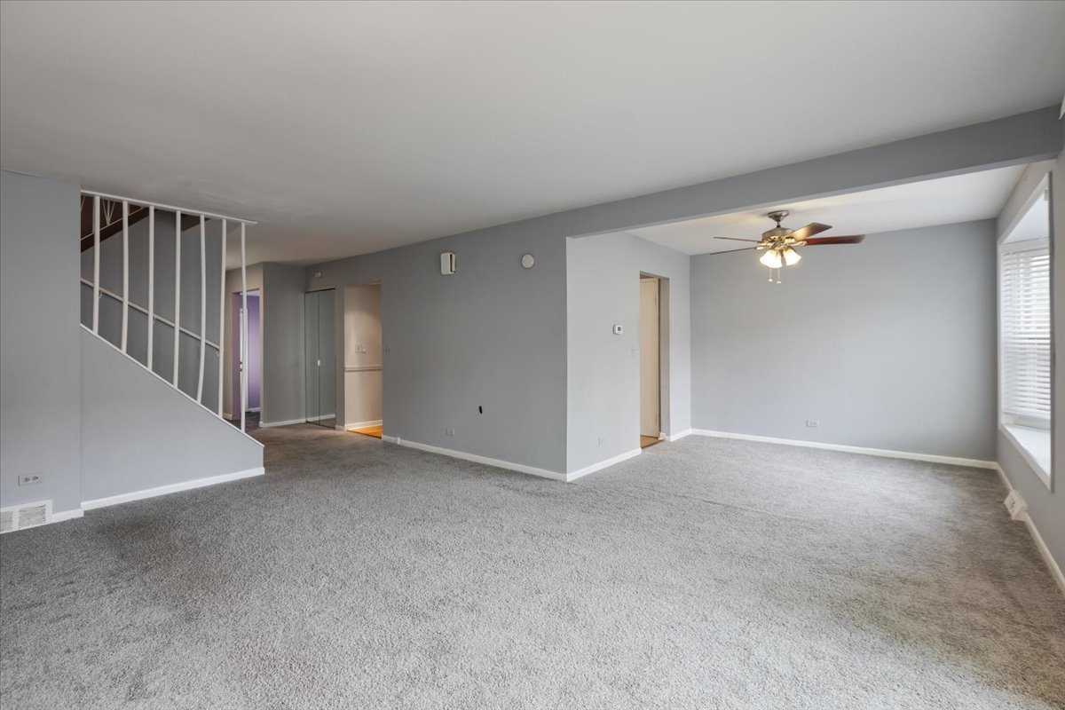 246 Monroe Road Bolingbrook, IL 60440 - Photo 8 of 32 a view of a livingroom with a ceiling fan and window