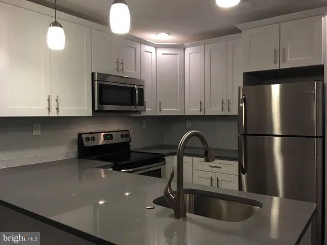a kitchen with a sink a microwave and refrigerator